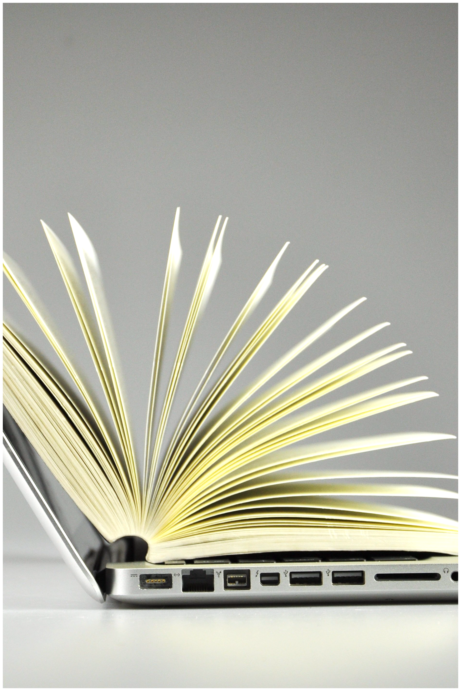 Book in library with old open textbook, stack piles of literature text archive on reading desk, and aisle of bookshelves in school study class room background for academic education learning concept